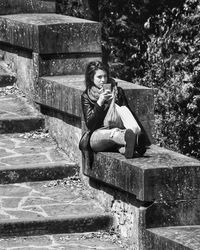 Portrait of woman sitting on staircase