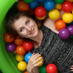 Portrait of smiling woman with colorful balloons