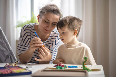 Mother using digital tablet at home