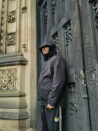 Man standing against building