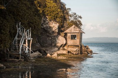 House by sea against sky