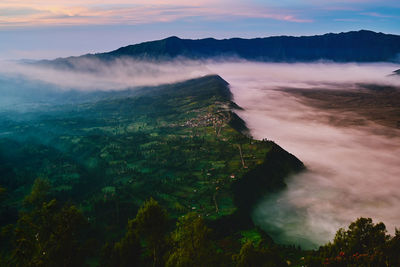 Aerial view of mountain against cloudy sky