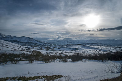 Scenic view of mountains against sky during winter