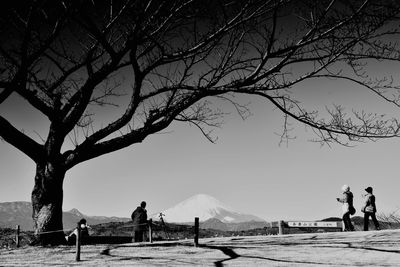 People on landscape against sky