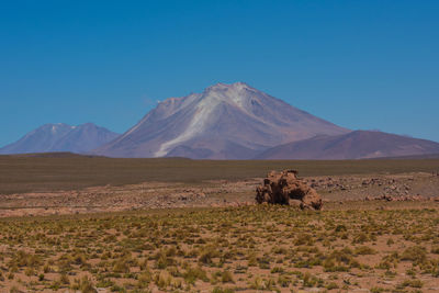 Scenic view of desert against clear blue sky