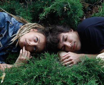 Portrait of woman lying down on grass