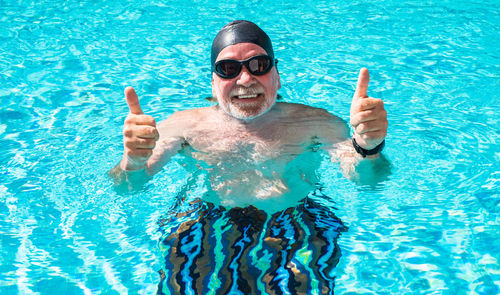 Portrait of smiling young man in swimming pool