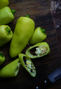 High angle view of green chili peppers on cutting board