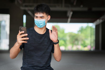 Close-up of man using mobile phone outdoors