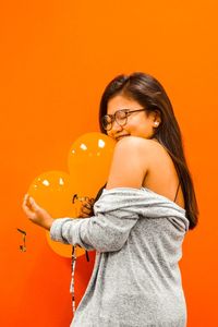 Young woman with orange hair against gray background