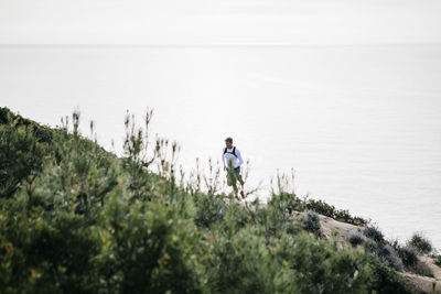 Rear view of man standing in water