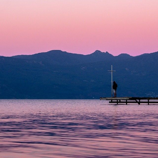 mountain, water, mountain range, waterfront, sunset, tranquil scene, tranquility, scenics, beauty in nature, lake, clear sky, nature, silhouette, rippled, idyllic, transportation, sea, nautical vessel, river, reflection