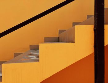 Close-up of yellow steps against sky during sunset