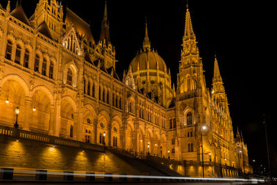 Illuminated buildings against sky in city at night