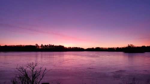 Scenic view of lake against sky during sunset