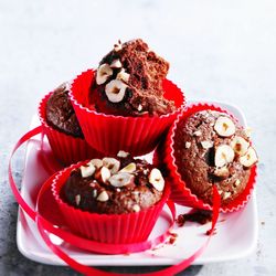 Close-up of cupcakes in plate against white background