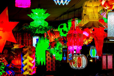 Illuminated lanterns hanging in market at night