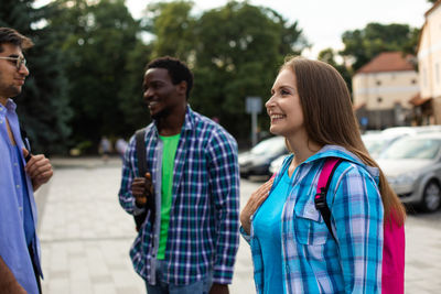 Rear view of people standing outdoors