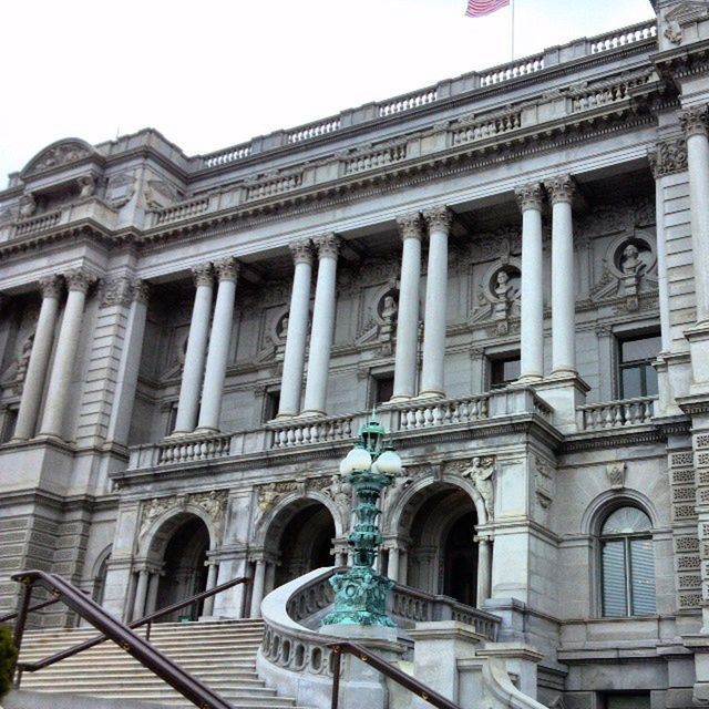 architecture, built structure, building exterior, low angle view, arch, architectural column, history, travel destinations, facade, famous place, clear sky, column, tourism, window, travel, art and craft, day, sculpture, capital cities, city