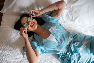 High angle view of woman lying on bed at home