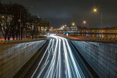 Light trails on road in city at night