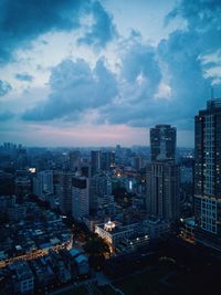 High angle view of illuminated buildings in city at dusk