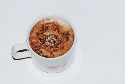 High angle view of coffee cup against white background