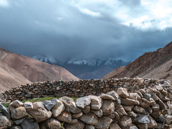 View of rocks and mountains against sky