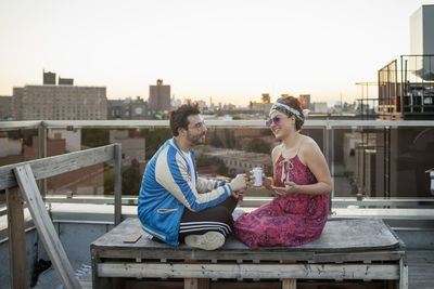 Friends sitting together on a rooftop