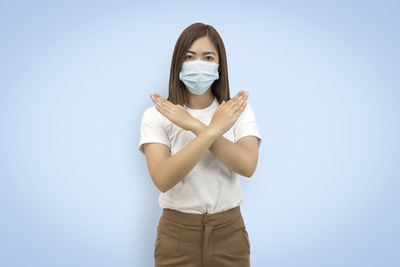 Portrait of woman standing against white background
