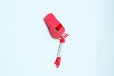 High angle view of red umbrella on table against white background