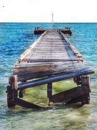 Pier over sea against clear sky