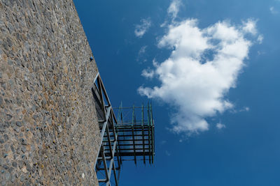 Low angle view of ladder against blue sky