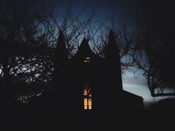 Low angle view of silhouette trees against sky at night