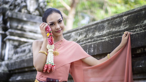 Portrait of a smiling young woman outdoors