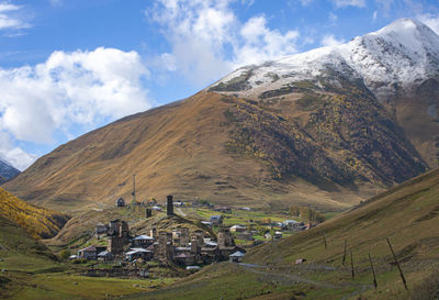 Panoramic view of houses and mountains against sky