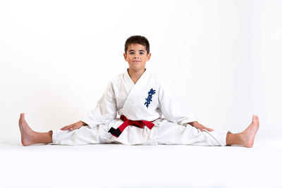Portrait of smiling woman standing against white background