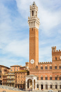 Low angle view of clock tower against sky