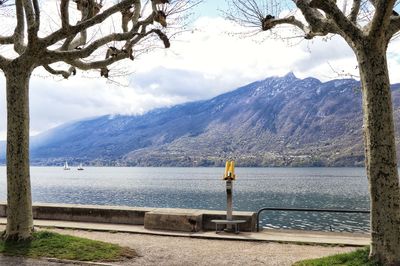 Scenic view of lake by mountains against sky