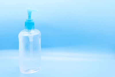 Close-up of water bottle against blue background