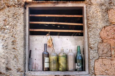 View of old bottles against window