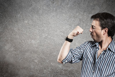 Full length of a man standing against wall