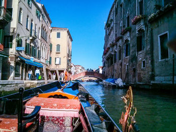 Boats in canal along buildings