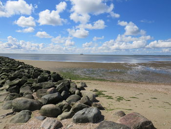 Rocks on beach against sky