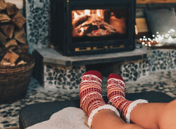 Low section of woman relaxing on sofa