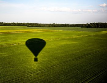 Shadow of hot air balloon on landscape