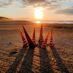 Sunlight falling on land against sky during sunset