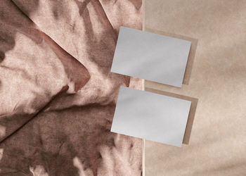 Blank white business cards with textile background. mockup for branding identity. 