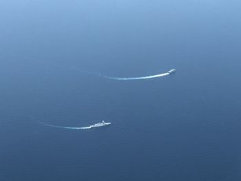 Aerial view of sea against blue sky