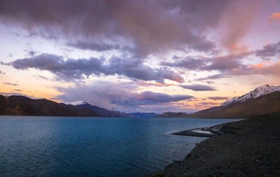 Scenic view of sea and mountains during sunset